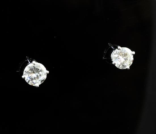 A pair of 18ct white gold and solitaire diamond ear studs,